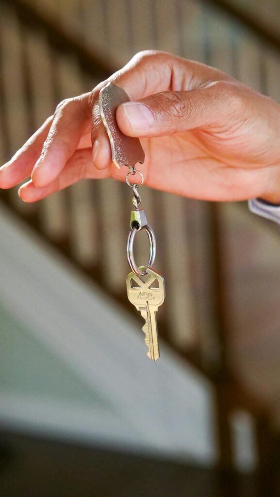 Close-up of a hand holding a key, symbolizing new homeownership or rental.